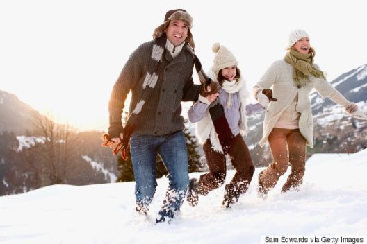 Family running outdoors in snow